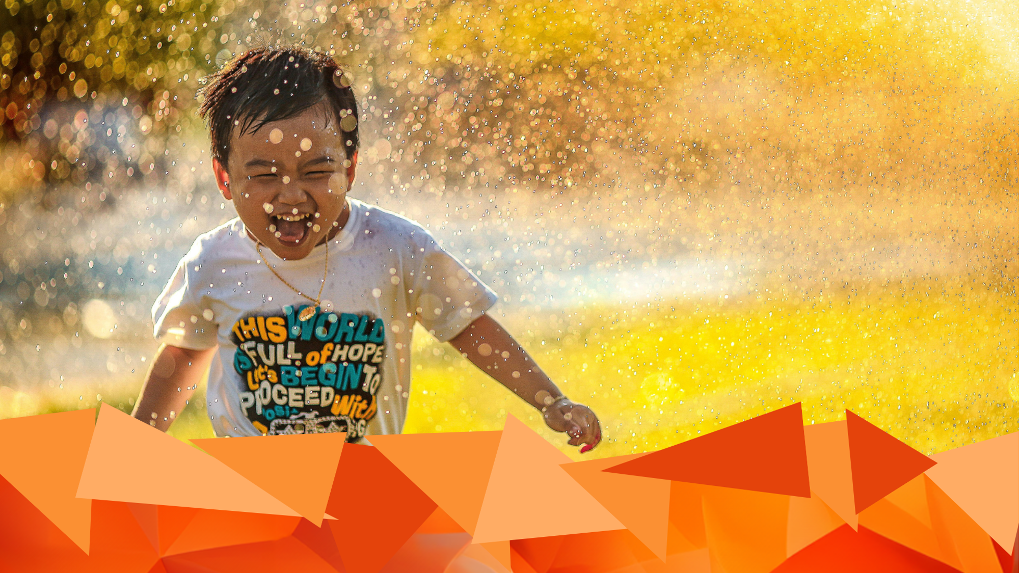 photoog young boysrunning through sprinkling water, symbol forPowerLink Project